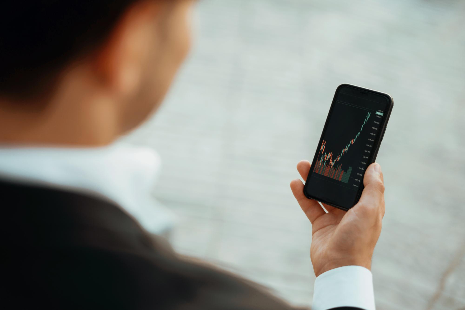 trader trades stock exchange his phone